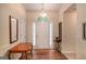 Inviting foyer showcasing beautiful wood floors, a bright entry door and detailed trim work at 161 Bradford Pl, Stockbridge, GA 30281