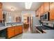 Functional kitchen with wooden cabinets, stainless steel appliances, and views into the dining area at 161 Bradford Pl, Stockbridge, GA 30281