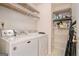 Bright laundry room features a white washer and dryer and plenty of wire rack shelving at 161 Bradford Pl, Stockbridge, GA 30281