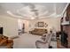 Comfortable living room with a brick fireplace, neutral carpet and a spacious layout for entertaining at 161 Bradford Pl, Stockbridge, GA 30281