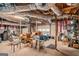 The unfinished basement has an exposed ceiling and walls, storage racks, and a garage door at 161 Bradford Pl, Stockbridge, GA 30281