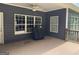 Covered back porch with a ceiling fan, a grill, and view of backyard at 180 Cooper Rd, Social Circle, GA 30025