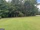 Spacious backyard with lush green grass, perfect for outdoor activities and entertaining at 180 Cooper Rd, Social Circle, GA 30025
