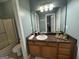 Bathroom features a granite countertop vanity, decorative decor, and tile flooring at 180 Cooper Rd, Social Circle, GA 30025
