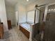 Bathroom with shower, jetted tub, tiled floors, and wooden cabinets at 180 Cooper Rd, Social Circle, GA 30025