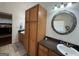 Bathroom with double vanities, granite countertops, tiled floors and dark wood cabinets at 180 Cooper Rd, Social Circle, GA 30025