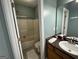 Cozy bathroom with a shower-tub combo, wood vanity and neutral wall color at 180 Cooper Rd, Social Circle, GA 30025
