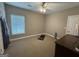 Bedroom with neutral walls features a ceiling fan and a window for natural lighting at 180 Cooper Rd, Social Circle, GA 30025