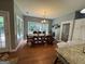 Bright dining room with a large window, wooden table, and decorative chandelier at 180 Cooper Rd, Social Circle, GA 30025