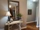 Welcoming entryway with elegant console table, decorative mirror, and hardwood floors at 180 Cooper Rd, Social Circle, GA 30025