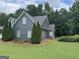Charming home featuring a well-maintained lawn and mature trees and shrubs at 180 Cooper Rd, Social Circle, GA 30025