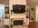 Elegant fireplace with built-in shelves, a mantel, and a large television above at 180 Cooper Rd, Social Circle, GA 30025