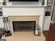 White fireplace with hearth, black screen and decorative accessories at 180 Cooper Rd, Social Circle, GA 30025