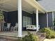 Welcoming front porch with white columns, porch swing, rocking chairs, and cozy decor at 180 Cooper Rd, Social Circle, GA 30025