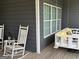 Inviting front porch with rocking chairs and a porch swing provides a relaxing outdoor space at 180 Cooper Rd, Social Circle, GA 30025