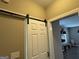 Hallway featuring a white sliding barn door with black hardware at 180 Cooper Rd, Social Circle, GA 30025