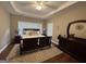 Bright bedroom with trey ceiling, fan, dark furniture, hardwood floors and an oversized rug at 180 Cooper Rd, Social Circle, GA 30025
