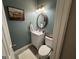 Chic powder room with modern fixtures, vanity, and a decorative mirror at 180 Cooper Rd, Social Circle, GA 30025