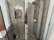 Shower with tiled walls and pebble rock floor and clear glass doors at 180 Cooper Rd, Social Circle, GA 30025