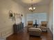 Cozy sitting room with white shiplap walls, tufted chairs, and a stylish chandelier at 180 Cooper Rd, Social Circle, GA 30025