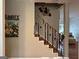 Elegant stairway with dark metal railing and wood steps at 180 Cooper Rd, Social Circle, GA 30025