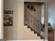 A wooden staircase with decorative iron railings and a decorative plate gallery wall at 180 Cooper Rd, Social Circle, GA 30025