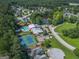 Aerial view of residential community, pond, pool, tennis court, and wooded areas at 301 Retreat Way, Carrollton, GA 30116