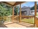 View of backyard and home from the wooden back deck with wood railing at 301 Retreat Way, Carrollton, GA 30116