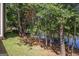 View of the wooded backyard area and lake with mature trees and side of home at 301 Retreat Way, Carrollton, GA 30116