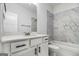 Bright bathroom featuring marble-style tile and vanity with storage at 301 Retreat Way, Carrollton, GA 30116