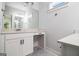 A bright bathroom featuring white cabinets, black hardware, a large mirror, and a white countertop at 301 Retreat Way, Carrollton, GA 30116
