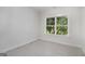 Bedroom with a large window with view of backyard trees, and neutral-toned walls and flooring at 301 Retreat Way, Carrollton, GA 30116