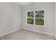 Bedroom with large window offering a peaceful view of the surrounding trees at 301 Retreat Way, Carrollton, GA 30116