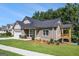 Craftsman home boasts an attached garage, covered front porch, and a waterside covered deck for outdoor enjoyment at 301 Retreat Way, Carrollton, GA 30116