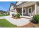 Craftsman-style house features a covered front porch, two-car garage, and manicured landscaping at 301 Retreat Way, Carrollton, GA 30116