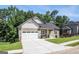 Charming home features a well-manicured lawn, attached garage, and craftsman details under a blue sky at 301 Retreat Way, Carrollton, GA 30116