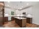 Kitchen with island, white cabinets, and stainless steel appliances at 301 Retreat Way, Carrollton, GA 30116