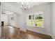 Open-concept living room boasts lots of natural light, wood floors, and easy access to the rest of the home at 301 Retreat Way, Carrollton, GA 30116