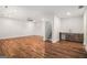 Spacious living room with hardwood floors, recessed lighting, and a wet bar with dark wood cabinets at 301 Retreat Way, Carrollton, GA 30116