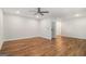 Open-concept living room with ceiling fan, hardwood floors, and recessed lighting at 301 Retreat Way, Carrollton, GA 30116