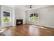 This brightly lit living room has wood flooring, a ceiling fan, and a modern fireplace at 301 Retreat Way, Carrollton, GA 30116