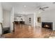 Bright, open-concept living area features hardwood floors, fireplace, and views into the kitchen with a staircase at 301 Retreat Way, Carrollton, GA 30116