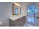 Contemporary bathroom with grey vanity, quartz countertop, and a large mirror, providing a modern aesthetic at 5106 N Pratt St, Covington, GA 30014