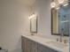 Light filled bathroom features a dual sink vanity with chrome fixtures and a tiled shower at 5106 N Pratt St, Covington, GA 30014