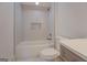 Modern bathroom featuring white subway tile, a built-in niche, and a soaking tub, next to the toilet and vanity at 5106 N Pratt St, Covington, GA 30014