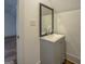 Bathroom showcasing a vanity with a gray cabinet and a well-lit mirror at 5106 N Pratt St, Covington, GA 30014