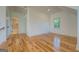 Bedroom with hardwood floors, connecting to a bathroom, with a view from the stairs at 5106 N Pratt St, Covington, GA 30014