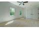 Inviting bedroom with carpet, double windows and closets, enhanced by natural light and a ceiling fan at 5106 N Pratt St, Covington, GA 30014