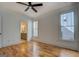 Bright and airy bedroom features hardwood floors, two windows, and an ensuite bathroom at 5106 N Pratt St, Covington, GA 30014
