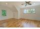 Bright bedroom with hardwood floors, a ceiling fan, and two large windows that bring in ample natural light at 5106 N Pratt St, Covington, GA 30014